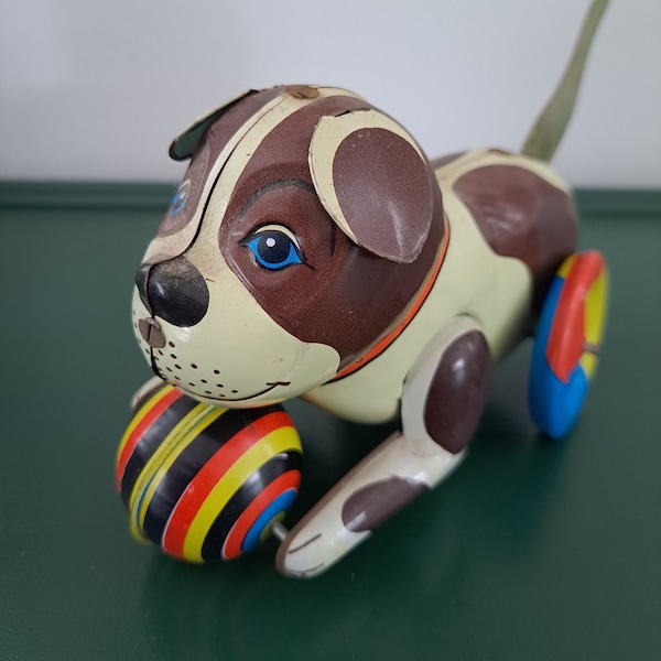 Vintage metal dog and ball push toy. 1970’s tin toy dog. Push & Go tail toy puppy dog wind up rolls on wheels. Vintage toy collection