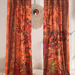 May include: Two orange curtains with a tree of life design. The curtains feature a detailed pattern in red, green, and blue. They hang in front of a white wall. The text "old soul linen" is visible on the right curtain.