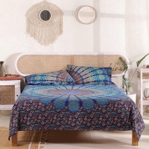 May include: A blue and green mandala patterned bedspread with matching pillowcases on a white bed frame with a woven headboard.