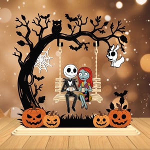 May include: A Halloween-themed wooden decoration featuring Jack Skellington and Sally from The Nightmare Before Christmas on a swing. The black tree has an owl, bats, and a spiderweb. Orange jack-o'-lanterns sit below the swing.