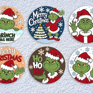 May include: A collection of six round Christmas ornaments featuring the Grinch in a Santa hat. Each ornament has a different design, including the phrases "Grinch Was Here", "Merry Christmas", and "Hi". The ornaments are in shades of green, red, and brown.