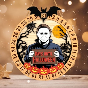 May include: Wooden Halloween countdown sign featuring a depiction of Michael Myers holding a sign that reads "DAYS UNTIL HALLOWEEN." The sign has a bat at the top and a ring with numbers. Orange pumpkins are at the bottom.