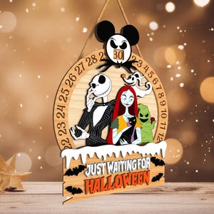 May include: Wooden Halloween countdown sign featuring Jack Skellington, Sally, Zero, and Oogie Boogie. The sign has a Mickey Mouse head with the number 30. The text "JUST WAITING FOR HALLOWEEN" is displayed on the bottom. The sign is designed with a circular shape and a wooden finish.