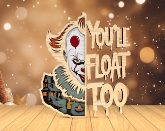 May include: Wooden cutout featuring a menacing clown face with a red balloon, a haunted house, and the phrase "You'll Float Too." The design is layered with natural wood tones and painted details, creating a spooky, decorative piece.