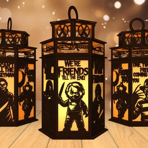 May include: Three black Halloween lanterns with cut-out designs and text. Each lantern features a different horror movie character and quote, including "You Can't Kill the Boogeyman" and "We're Friends Till the End."