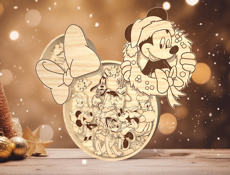 May include: A wooden Christmas ornament featuring Mickey Mouse and Minnie Mouse with other Disney characters. The ornament is shaped like Minnie Mouse's head with a large bow and a wreath around Mickey Mouse's head.