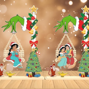 Könnte beinhalten: Weihnachtliche Dekorationsfiguren mit Aladdin-Charakteren. Jede Figur enthält eine Grinch-Hand, eine Schaukel mit Jasmin oder Jasmin und Aladdin, einen Weihnachtsbaum und Abu mit einer Lampe.