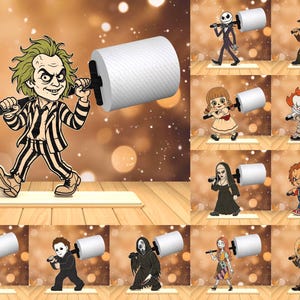 May include: A selection of cartoon characters, each depicted carrying a roll of toilet paper. The characters include Beetlejuice, Jack Skellington, Freddy Krueger, Annabelle, Pennywise, The Nun, Chucky, Jason Voorhees, Michael Myers, Ghostface, Sally, and Tiffany.