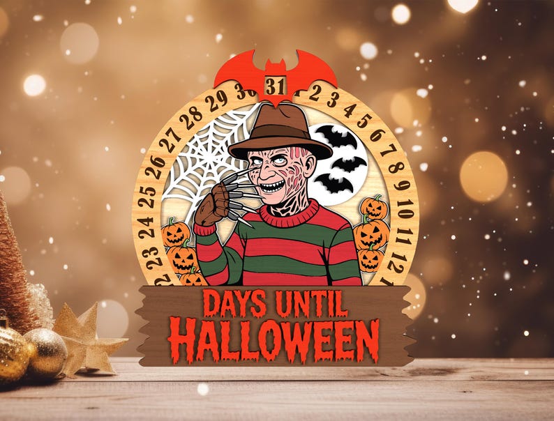 May include: A wooden Halloween countdown calendar featuring a character with a hat and striped sweater. The calendar has a circular design with numbers, pumpkins, bats, and a spiderweb. The text "DAYS UNTIL HALLOWEEN" is displayed on a wooden sign.