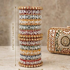 Könnte beinhalten: Ein Stapel mehrfarbiger Armreifen mit Spiegelverzierungen und goldfarbenen Akzenten sowie eine passende rechteckige Clutch. Der Stapel hat eine Länge von 7,5 bis 8 Zoll und eine Breite von 3,2 bis 3,5 Zoll, wie im Bildtext angegeben.