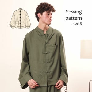 May include: An olive green jacket featuring a mandarin collar, long sleeves, and a front closure with four fabric toggle buttons. The garment includes a chest pocket and a technical line drawing illustration labelled Sewing pattern size S.