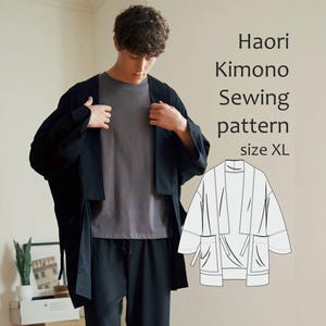 May include: A person wearing a black Haori kimono. The kimono is open at the front and has wide sleeves. The image also includes a diagram of the kimono and the text "Haori Kimono Sewing pattern size XL."