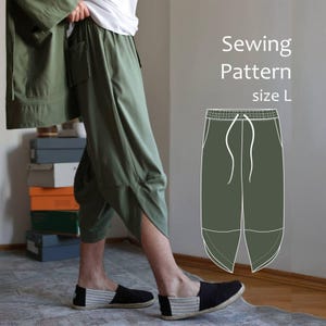 May include: Olive green trousers with a distinctive split-leg design. The trousers feature pockets and a drawstring waist. The image also includes a sewing pattern illustration of the trousers, with the text "Sewing Pattern size L".