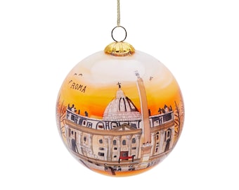 May include: A glass Christmas ornament with a painted image of the St. Peter's Basilica in Rome, Italy. The ornament is white with a gold top and a sunset-colored background. The text "ROMA" is painted on the ornament.