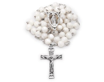 May include: White mother of pearl rosary beads with a silver crucifix and a silver charm of the Virgin Mary.