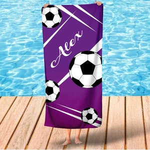 May include: Purple beach towel with white diagonal stripes and soccer balls. The name "Alex" is written in white cursive on the towel.
