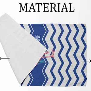 May include: A white beach towel with a blue and white chevron pattern. The towel has a pink flamingo illustration on the printed side. The back side of the towel is 100% cotton and the printed side is 100% polyester.