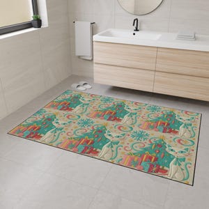May include: A rectangular bathroom rug with a repeating pattern of stylized white cats, Christmas trees, and wrapped gifts. The rug features a beige background with teal, red, pink, and yellow accents. The rug is placed on a tiled floor.