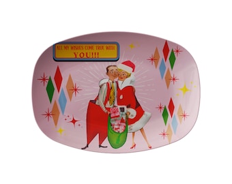 May include: Pink oval ceramic serving dish with a festive Christmas scene featuring a couple holding a bag of gifts. The text "All my wishes come true with YOU!!!" is printed on the dish.
