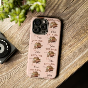 May include: A pink phone case with a repeating pattern of books and coffee cups. The text "Books & Coffee Just A Girl Who Loves" is repeated on the case.