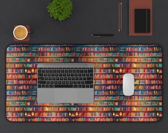 May include: A colourful desk mat with a bookshelf design featuring rows of colourful books. A laptop computer and a wireless mouse are on the mat.