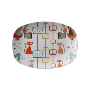 May include: White oval serving platter with a retro design featuring orange cats, blue and yellow stars, and red, yellow, and blue geometric shapes.