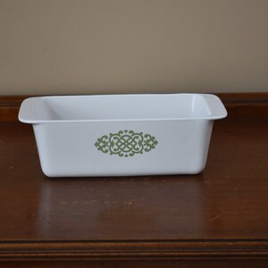 May include: White loaf pan with a green floral design.