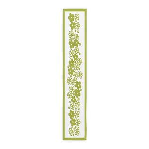 May include: A green and white floral patterned table runner. The runner has a green border and a white background with a repeating pattern of green flowers.