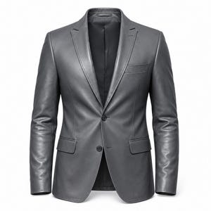 May include: A gray leather blazer with a two-button closure, notched lapels, and a chest pocket. The jacket has long sleeves and a tailored fit. The interior lining is black. The blazer is displayed against a white background.