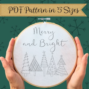 May include: A white embroidery hoop with the text "Merry and Bright" and a row of five stylized Christmas trees with different patterns.