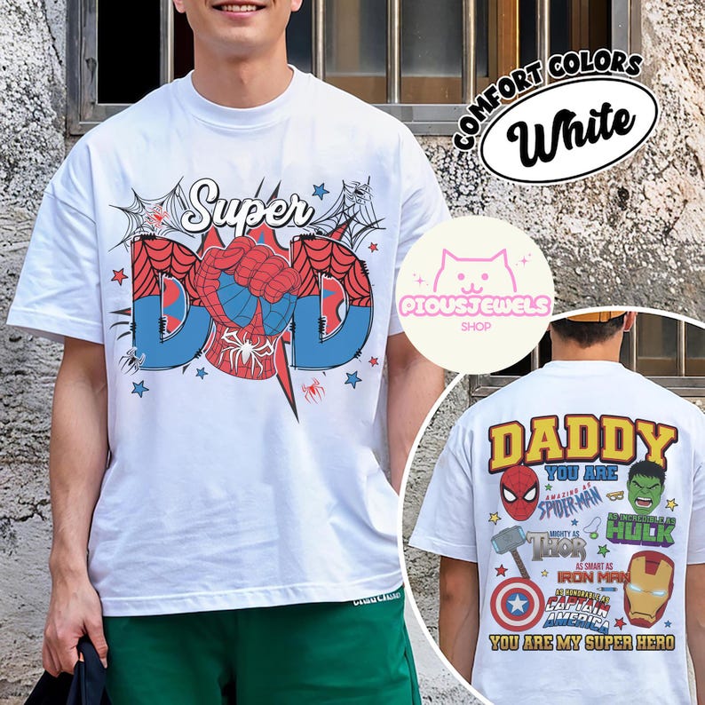 May include: A white t-shirt featuring a front graphic with the text Super DAD and a spider-web motif. The back graphic displays the text DADDY YOU ARE and lists various superhero characters including Spider-Man, Hulk, Thor, and Iron Man.