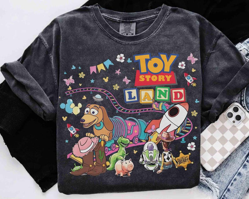 May include: A white ceramic mug with a black handle and the text "But First, Coffee" in a bold, black font. The mug is set against a blurred background, suggesting a cosy setting.