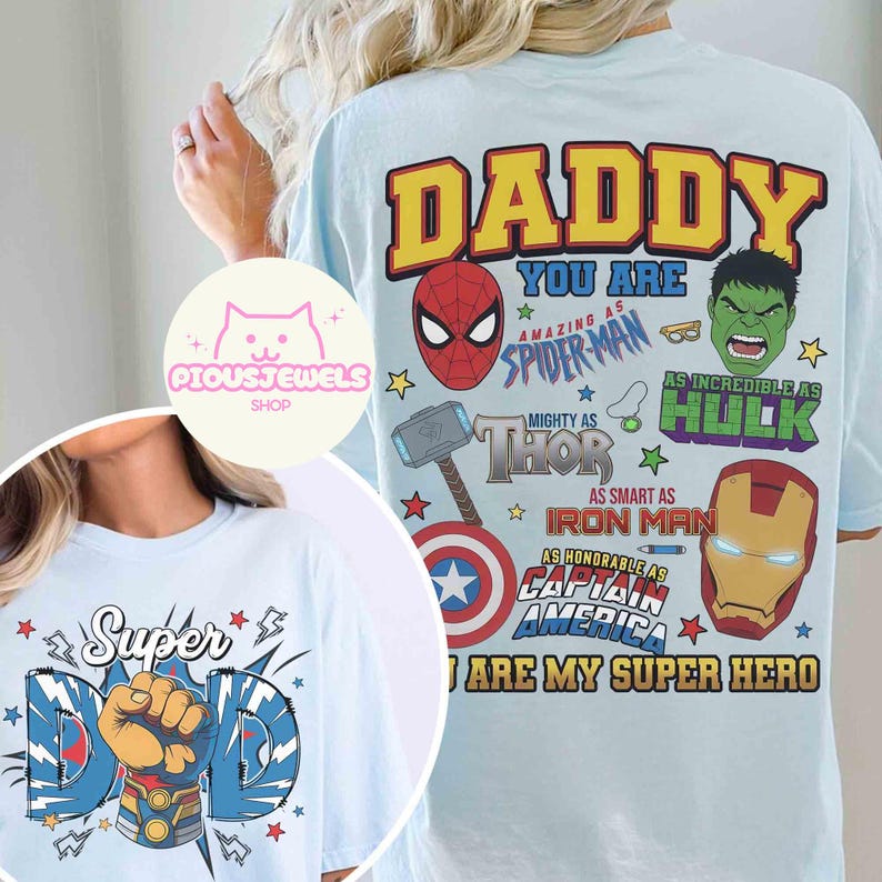 May include: A light blue t-shirt featuring a graphic print on the back with the text DADDY YOU ARE AMAZING AS SPIDER-MAN, AS INCREDIBLE AS HULK, MIGHTY AS THOR, AS SMART AS IRON MAN, AS HONORABLE AS CAPTAIN AMERICA, YOU ARE MY SUPER HERO.