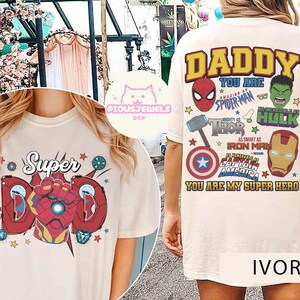 May include: An ivory t-shirt featuring a front graphic of a red armored gauntlet with the text Super Dad and a back graphic with the text DADDY YOU ARE AMAZING AS SPIDER-MAN INCREDIBLE AS HULK MIGHTY AS THOR SMART AS IRON MAN HONORABLE AS CAPTAIN AMERICA.