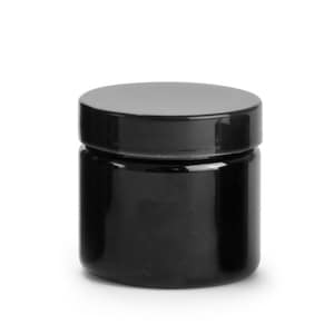 Puede incluir: Un tarro de vidrio negro con una tapa negra. El tarro está vacío y tiene una superficie lisa y brillante.