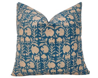 May include: A teal blue pillow with a cream floral pattern. The pillow is made of a soft, comfortable fabric and has a subtle sheen.