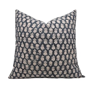 May include: A blue and white patterned cushion with a floral design. The cushion is made of a soft, comfortable fabric and is perfect for adding a touch of style to any room.