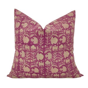 May include: A pink throw pillow with a cream floral pattern. The pillow is made of a soft, comfortable fabric and has a subtle sheen.