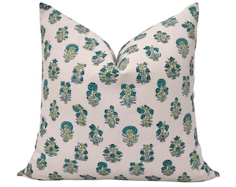 May include: A square decorative pillow with a cream-colored background. The pillow is covered in a repeating pattern of teal and light green floral designs. The pillow is a soft, comfortable accent piece for a bed or sofa.