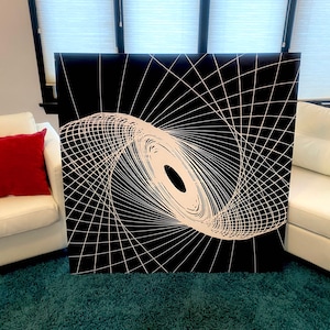 May include: A black and white abstract art print with a swirling, geometric design. The design features a white spiral shape on a black background.