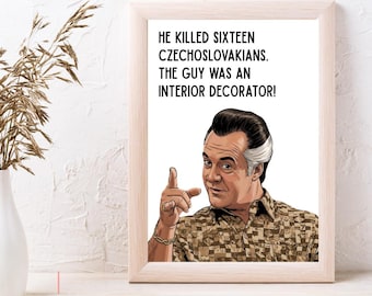 May include: A framed print featuring a stylized illustration of a man with dark hair and a gold bracelet, wearing a tan patterned shirt. The text reads: HE KILLED SIXTEEN CZECHOSLOVAKIANS. THE GUY WAS AN INTERIOR DECORATOR! The print is in a light wood frame.