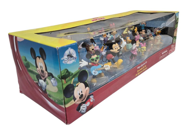 May include: A boxed set of Disney Mickey Mouse figurines. The box features Mickey Mouse graphics and a clear plastic window showcasing the figurines. The set includes various characters in colorful outfits, with Mickey playing a guitar.