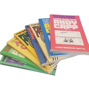 May include: A stack of vintage "Laugh Again with Andy Capp" comic books. The covers are in various colors, including green, yellow, blue, and red. The text on the covers includes "Laugh Again" and "Andy Capp".