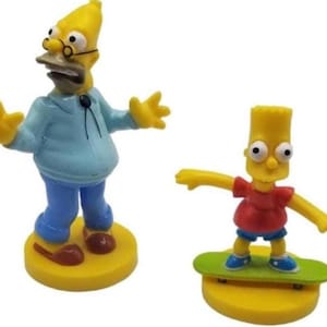 May include: Two yellow figurines of characters from The Simpsons. One figure is Homer Simpson, wearing a blue shirt, blue trousers, and glasses. The other is Bart Simpson, wearing a red shirt and blue shorts, riding a green skateboard.