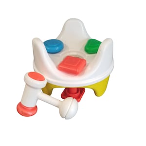 May include: A brightly coloured plastic toy with a white base, yellow details, and a red and white hammer. The toy has three holes with a blue circle, a green triangle, and a red square. A fun, educational toy for toddlers.