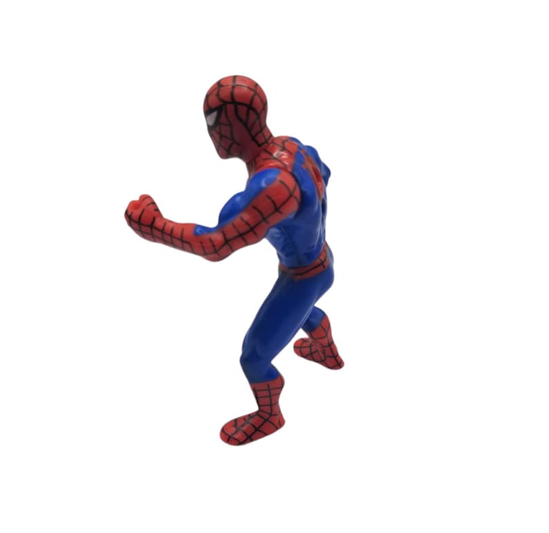 May include: A plastic Spider-Man action figure in a dynamic pose. The figure is primarily blue with red accents, including a mask and web-patterned sections. The figure is posed as if in motion, with one arm extended and legs bent.