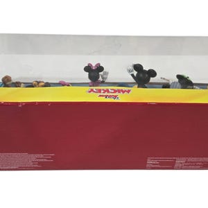 May include: A rectangular box with a clear plastic window, featuring Disney's Mickey Mouse characters. The box is red with yellow trim and the words "Disney Junior Mickey" are visible. Several Mickey Mouse figurines are inside.