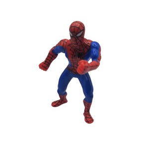 May include: A small Spider-Man action figure in a dynamic pose. The figure is predominantly red and blue, with a detailed web pattern on the red sections. The figure has a black spider emblem on the chest and is standing on a white background.