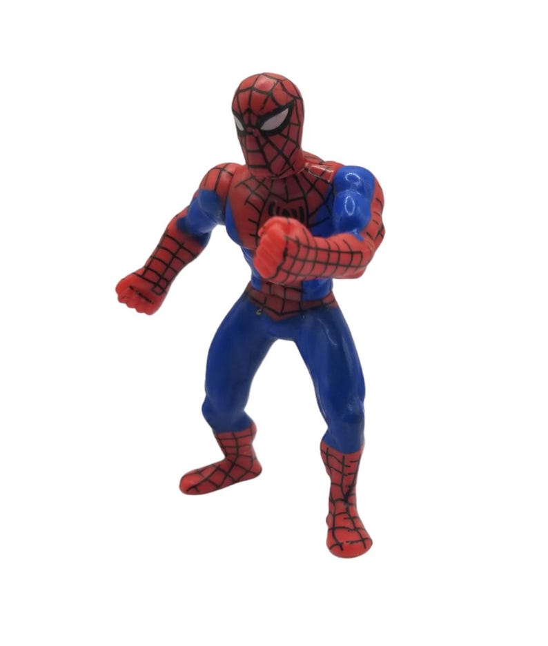 May include: A red, blue, and black Spider-Man action figure in a fighting pose. The figure has a red mask with white eyes, a red and black webbed suit, and blue accents. The figure is approximately 4 inches tall.