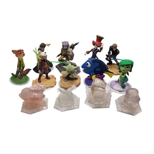May include: A collection of colourful character figurines, including a fox, a blue fish, and a green alien. The figurines are on clear plastic bases, and some have green or blue light sabers. The characters are from various animated movies.